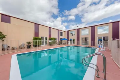 a swimming pool in front of a building at Best Western Canoga Park Motor Inn in Canoga Park