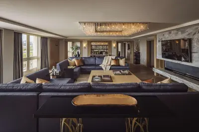 a living room with a blue couch and a table at L'Ermitage Beverly Hills in Los Angeles