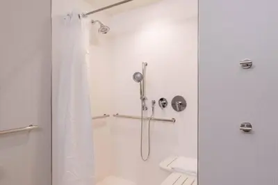 a bathroom with a shower with a shower curtain at Courtyard by Marriott Thousand Oaks Agoura Hills in Agoura Hills