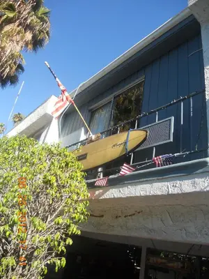 a surfboard sitting on the side of a building at Tradewinds Airport Hotel in Inglewood