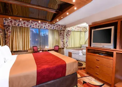 a hotel room with a bed and a television at Vagabond Inn Long Beach in Long Beach