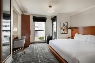 a hotel room with a large bed and a desk at FOUND Hotels, Santa Monica, Series by Marriott in Los Angeles