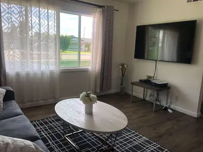 a living room with a table and a couch at Fully remodeled Beautiful house in West Covina in West Covina