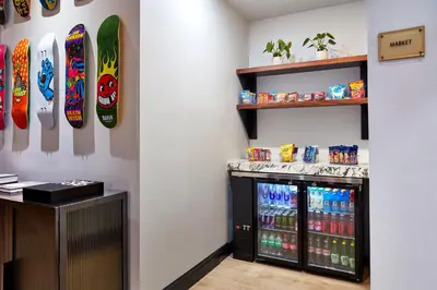 a store with soda machines and skateboards on the wall at Elan Hotel in Los Angeles