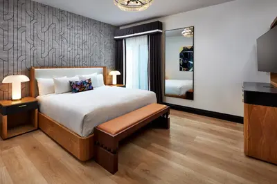 a bedroom with a large bed and a mirror at Elan Hotel in Los Angeles