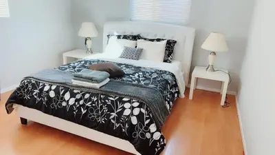 a bedroom with a bed with a black and white comforter at Pasadena single house 3b1b \u4e09\u623f\u4e00\u5385\u4e00\u53a8\u4e00\u6d74 in Pasadena