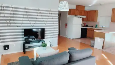 a living room with a couch and a table and a kitchen at Pasadena single house 3b1b \u4e09\u623f\u4e00\u5385\u4e00\u53a8\u4e00\u6d74 in Pasadena