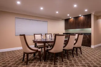 a dining room with a table and chairs at Beverly Hills Plaza Hotel & Spa in Los Angeles