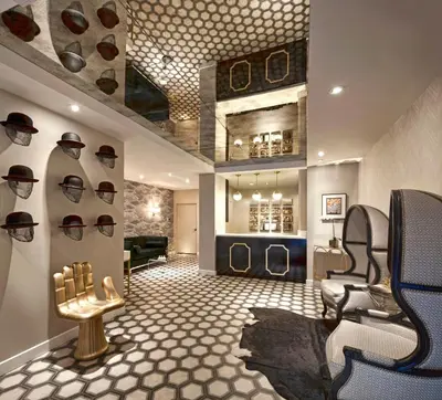 a room with a hair salon with hats on the wall at Carlyle Inn in Los Angeles