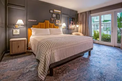 a bedroom with a large bed and a large window at Hotel Amarano Burbank-Hollywood in Burbank