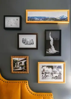 a wall with pictures on a wall with a chair at Hotel Amarano Burbank-Hollywood in Burbank