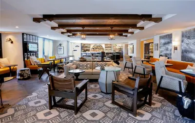 a living room with couches and tables and chairs at Hotel Amarano Burbank-Hollywood in Burbank