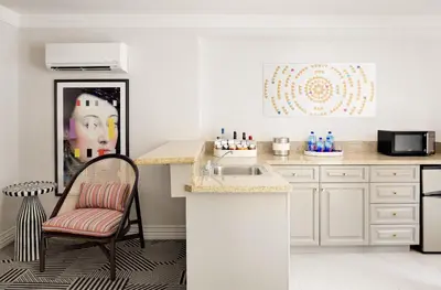 a kitchen with a sink and a chair next to a counter at Le Parc at Melrose in Los Angeles