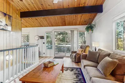 a living room with a couch and a table at The Treehouse in Lake Arrowhead