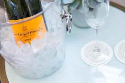 a bottle of wine in a bucket on a table at Mosaic Hotel Beverly Hills in Los Angeles
