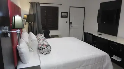 a hotel room with a bed and a television at Legend Hotel Hollywood in Los Angeles