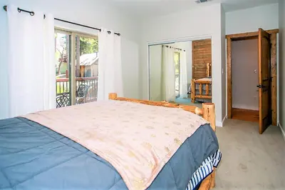 a bedroom with a bed and a balcony at Alpine Chalet-1840 by Big Bear Vacations in Big Bear Lake