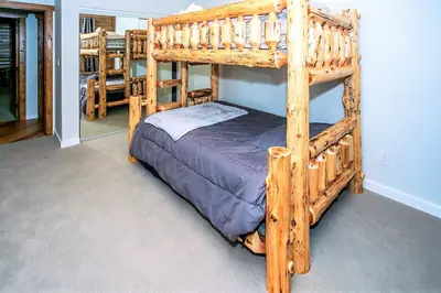 a bedroom with two bunk beds in a room at Alpine Chalet-1840 by Big Bear Vacations in Big Bear Lake