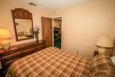 a bedroom with a bed and a mirror at Boulder Creek-1412 by Big Bear Vacations in Big Bear Lake