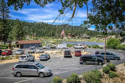 a parking lot with cars parked next to a lake at Boulder Creek-1412 by Big Bear Vacations in Big Bear Lake