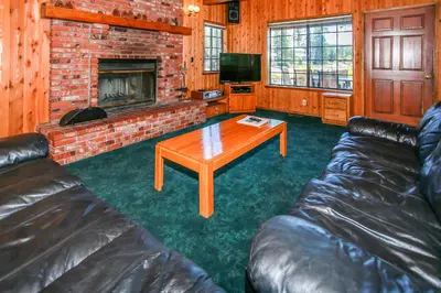 a living room with a couch and a fireplace at Breezy Estate-114 by Big Bear Vacations in Big Bear Lake
