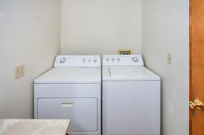 two white appliances in a small white kitchen at Breezy Estate-114 by Big Bear Vacations in Big Bear Lake