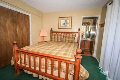 a bedroom with a wooden bed in a room at Boulder Creek -1417 by Big Bear Vacations in Big Bear Lake