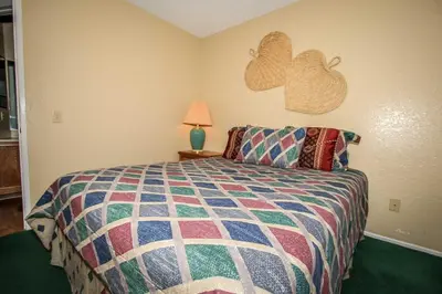 a bedroom with a bed and two hearts on the wall at Boulder Creek -1417 by Big Bear Vacations in Big Bear Lake