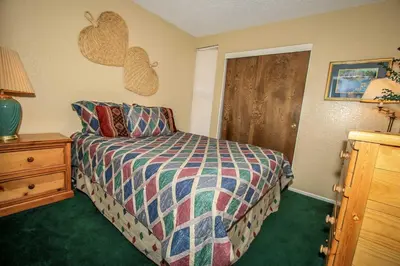 a bedroom with a bed with a colorful comforter at Boulder Creek -1417 by Big Bear Vacations in Big Bear Lake