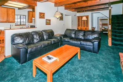 a living room with a leather couch and a coffee table at Breezy One-112 by Big Bear Vacations in Big Bear Lake