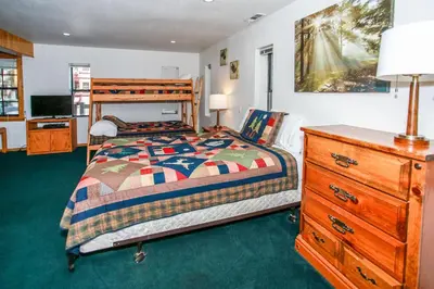 a bedroom with a bed and a dresser at Breezy One-112 by Big Bear Vacations in Big Bear Lake