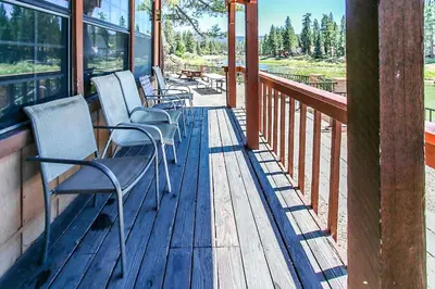 a row of chairs sitting on a porch at Breezy Two-113 by Big Bear Vacations in Big Bear Lake