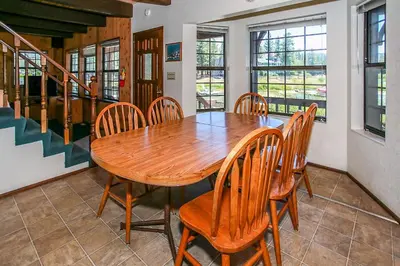 a dining room with a wooden table and chairs at Breezy Two-113 by Big Bear Vacations in Big Bear Lake