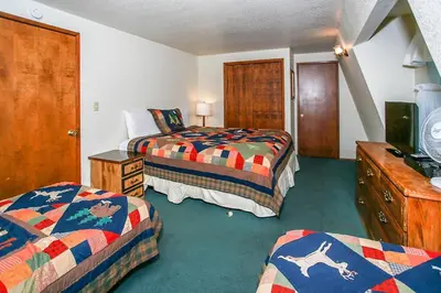 a hotel room with two beds and a tv at Breezy Two-113 by Big Bear Vacations in Big Bear Lake