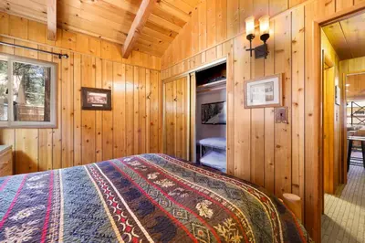 a bedroom with a bed in a wooden cabin at Oriole Cottage-621 by Big Bear Vacations in Big Bear Lake