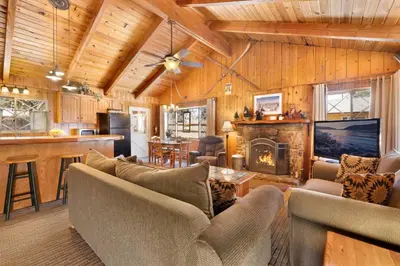 a living room with a couch and a fireplace at Oriole Cottage-621 by Big Bear Vacations in Big Bear Lake
