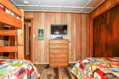 a bedroom with two beds and a flat screen tv at Frank's Old Bear-149 by Big Bear Vacations in Big Bear Lake