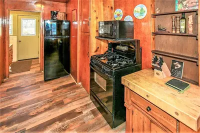 a kitchen with a stove and a refrigerator at Frank's Old Bear-149 by Big Bear Vacations in Big Bear Lake