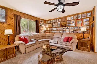 a living room with a couch and a ceiling fan at Popko's Place Resort Chalet by Big Bear Vacations in Big Bear Lake