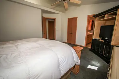 a bedroom with a bed and a flat screen tv at Can't Bear to Leave-1156 by Big Bear Vacations in Big Bear Lake