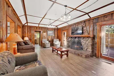 a living room with a couch and a fireplace at Shore Acres Lodge-451 by Big Bear Vacations in Big Bear Lake