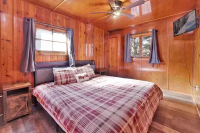 a bedroom with a bed and a ceiling fan at Shore Acres Lodge-451 by Big Bear Vacations in Big Bear Lake