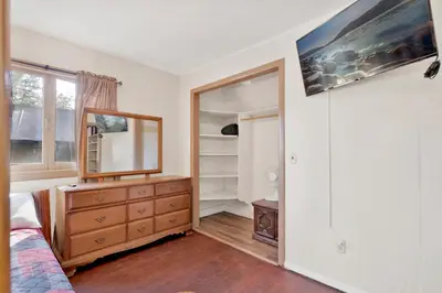 a bedroom with a dresser and a mirror at Shore Acres Lodge-451 by Big Bear Vacations in Big Bear Lake