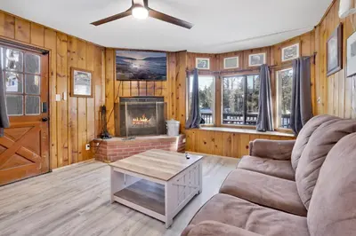 a living room with a couch and a fireplace at Shore Acres Lodge-450 by Big Bear Vacations in Big Bear Lake
