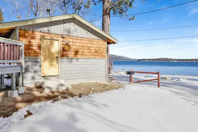 a small house with a door in the snow at Shore Acres Lodge-450 by Big Bear Vacations in Big Bear Lake