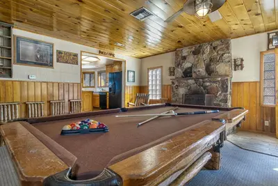 a pool table in the middle of a room at Lake Shore Family Cabin w Hot Tub and Pool Table by Big Bear Vacations in Big Bear Lake