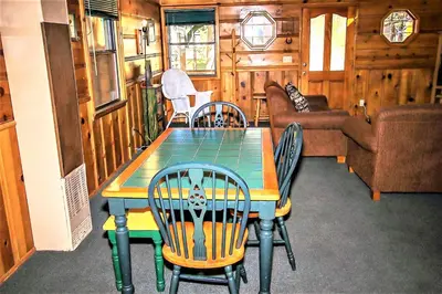 a dining room with a table and chairs at Kelley's Kabin-290 by Big Bear Vacations in Big Bear Lake