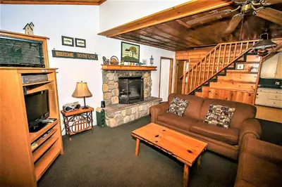 a living room with a couch and a fireplace at Kelley's Kabin-290 by Big Bear Vacations in Big Bear Lake