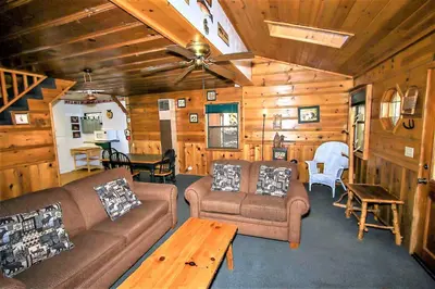 a living room with couches and a ceiling fan at Kelley's Kabin-290 by Big Bear Vacations in Big Bear Lake