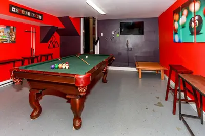 a pool table in a room with red walls at Fawnskin Chalet-1826 by Big Bear Vacations in Fawnskin